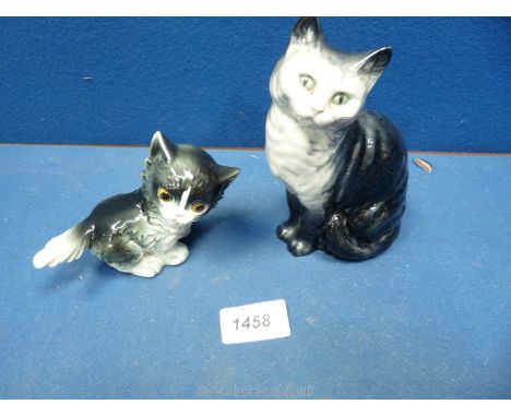 A Beswick seated cat with smoky blue, grey and white fur and green eyes and similar Goebel kitten with orange eyes. 