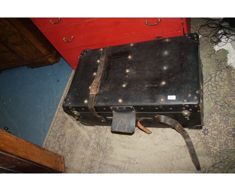 A large black leather Travel trunk with studs and straps having shelf inside (handle missing), 32 1/2" x 19" x 13".