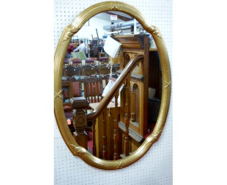 A modern reeded gilt framed oval wall mirror in the French taste, 89 x 66cm