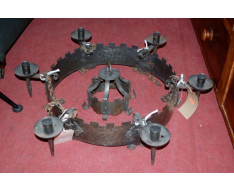 A medieval style steel hanging ceiling light, having six integral candle sconce holders