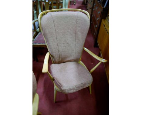 An Ercol blond elm stickback armchair; together with one other similar example (2) 