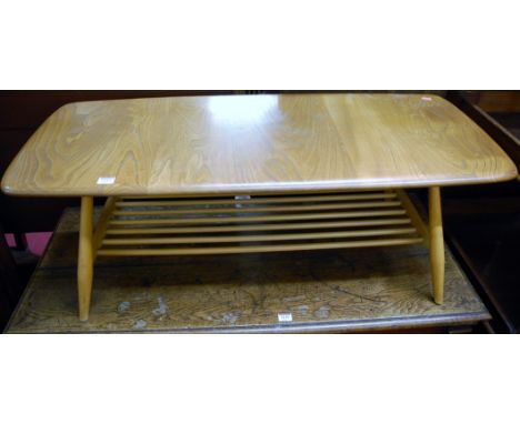 An Ercol blond elm low coffee table having laddered undertier