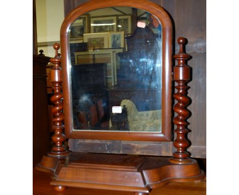 A mid-Victorian mahogany swing toilet mirror, raised on spiral turned uprights