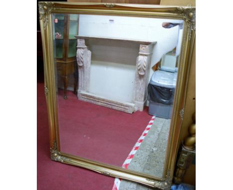 A modern gilt framed bevelled rectangular wall mirror, 131x103cm
