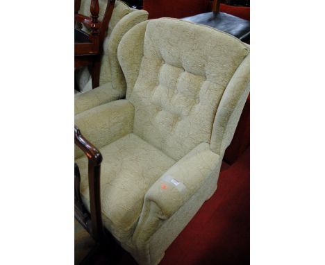 A modern floral upholstered buttonback three piece suite comprising; two-seater sofa and pair of wingback armchairs 