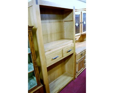 A contemporary light oak freestanding open bookshelf having twin short central drawers, width 100cm