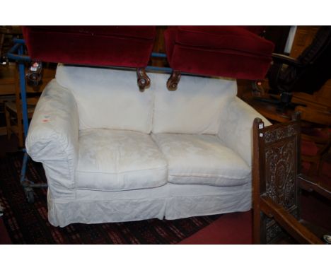 A modern cream floral upholstered two-seater sofa