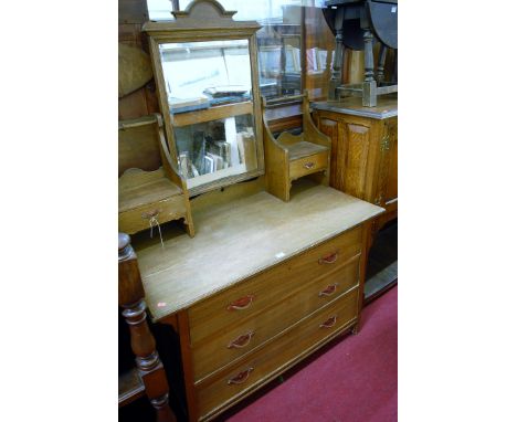 An Art Nouveau oak mirror back dressing chest having shaped copper handles, width 107cm