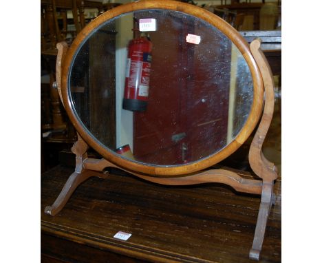 A circa 1900 mahogany oval swing toilet mirror