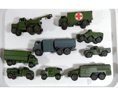 A selection of die cast Dinky vehicles: Military ambulance 626; armoured personnel carrier; Army 1 ton cargo truck; armoured 