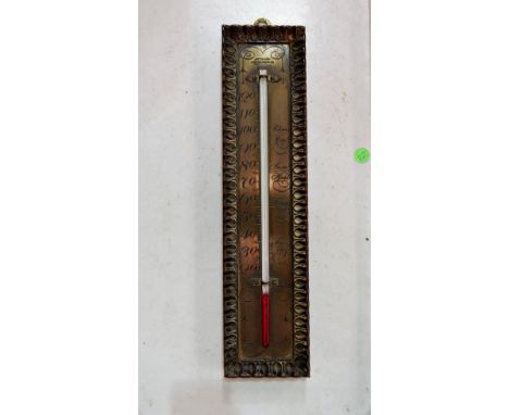 An early 20th century thermometer with engraved brass scale and carved oak mount by Aitchison, 11inches