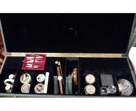 A green leather effect collector's case with a selection of lights, collectables etc inside, button hooks etc