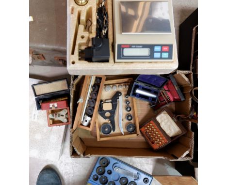 A selection of watchmaker's tools and equipment; an Ohaus ''port o gram'' electric weighing scale