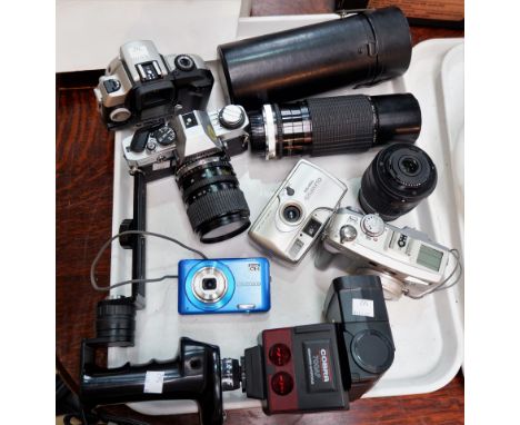 An Olympus OMG SLR camera, a Sigma zoom lens, another Nikon lens, other related items