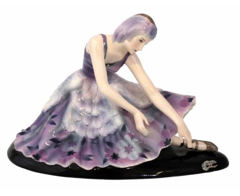 Goldscheider figure of a ballerina designed by Stefan Dakon, dressed in purple floral dress, the base marked with facsimile s