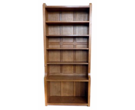 Robert "Mouseman" Thompson light oak bookcase, fitted two fixed and four adjustable shelves with wooden pegs, six panel back 