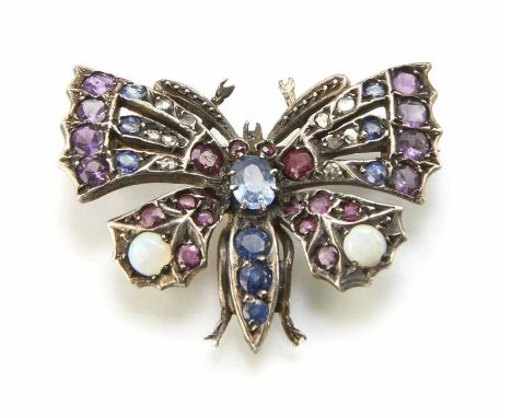 Sapphire, ruby, diamond and opal set silver butterfly brooch, the central oval blue sapphire approx. 5mm x 3.5mm. The body an