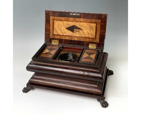 A Regency sarcophagus tea caddy of multiple specimen woods, the hinged lid revealing a central green tinged cut glass mixing 