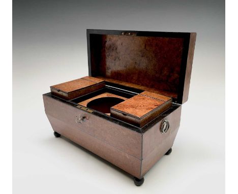 A Regency burr walnut tea caddy, of sarcophagus form, the interior with two hinged compartments, on metal bun feet, height 18
