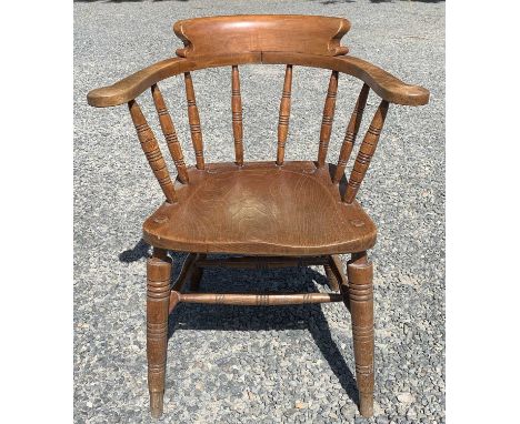 An elm and beech smokers bow armchair, early 20th century, stamped 'HB' to the rear of the seat and 'CRV' to the underside, h