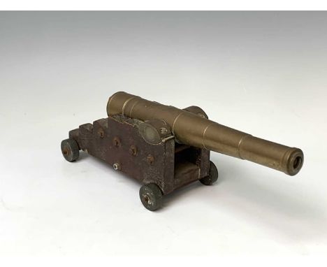 A brass model of a cannon, late 19th/early 20th century, with an oak carriage, length of barrel 33cm, full length 40cm, heigh