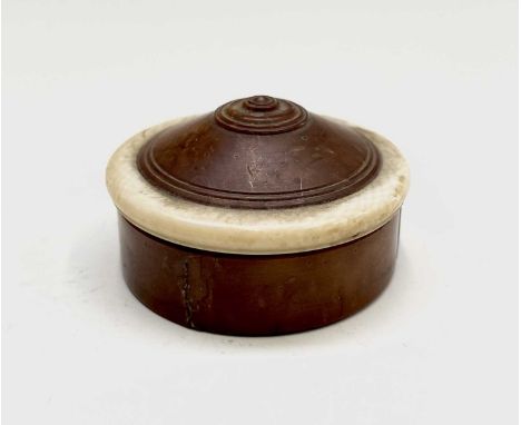 An early 19th century treen and ivory pill box, height 2.5cm, diameter 4.5cm.Provenance:Michael Trethewey. A Gentleman of Tas