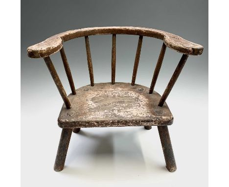 A beech and elm stick back primitive child's chair, 19th century, bearing traces of original paint, height 42cm, width 43cm, 