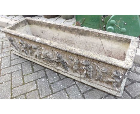 A reconstituted garden trough planter (broken into several sections), length 120cm