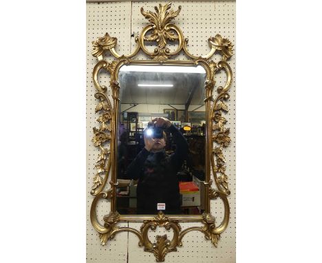 A pierced floral gilt framed circular bevelled wall mirror, dia. 77cm, together with a further composite gilt framed wall mir