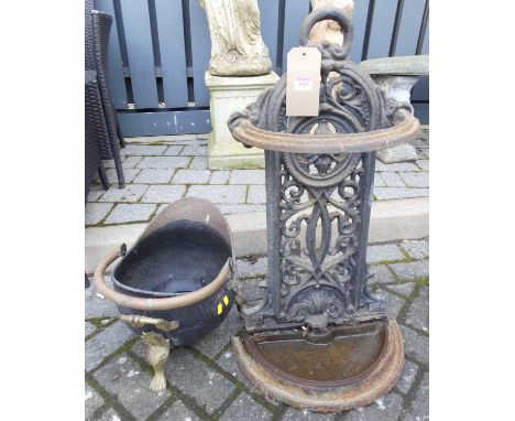 A Victorian cast iron demi-lune stick stand, having pierced floral decoration, together with a brass and copper swing handled