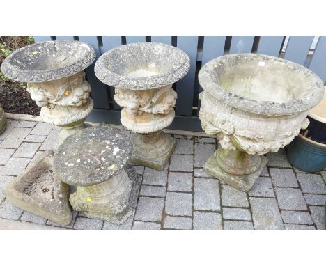 A pair of reconstituted stone pedestal garden urn planters in the classical taste (one with heavy damages to outer edge), tog