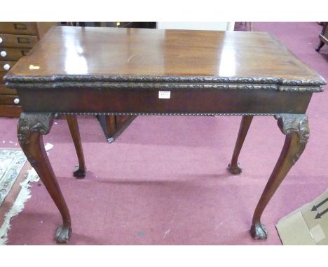 A circa 1900 mahogany fold-over baize lined card table, having rear gateleg action, raised on acanthus leaf carved cabriole s