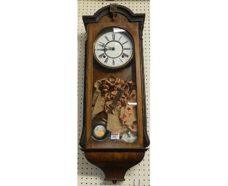 An early 20th century walnut and ebonised drop trunk Vienna type wall clock 