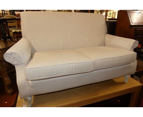 A contemporary Multiyork cream floral upholstered two-seater sofa, raised on squat reeded tapering forelegs, width 155cm