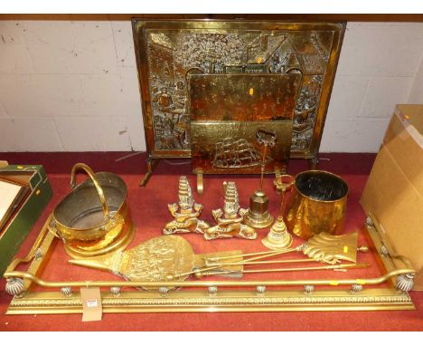 Assorted brassware, to include a fender, w.133cm; pair of andirons; two brass fire guards; bellows; fuel depots; companion wa