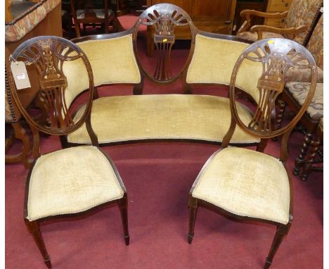 An Edwardian mahogany, floral satinwood, ivory inlaid and penwork decorated seven-piece salon suite, comprising; a two-seater