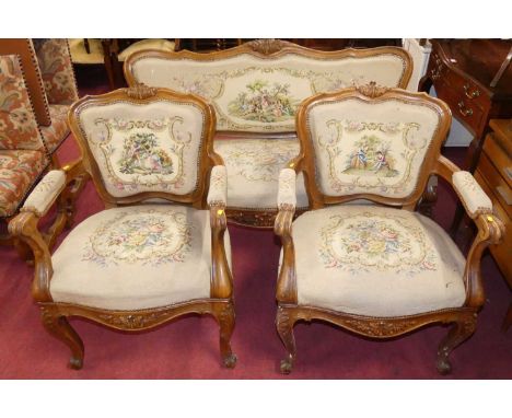 A French beech framed three-piece salon suite, comprising; a three-seater sofa and a pair of armchairs, each needlework uphol