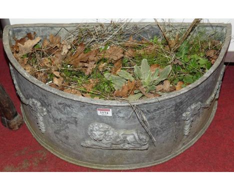 A demi-lune lead garden planter, with raised lion and swag motifs, width 60cm