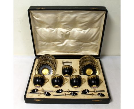 Royal Worcester black and gilt coffee set for six settings (one cup lacking), with six black and white enamelled silver coffe