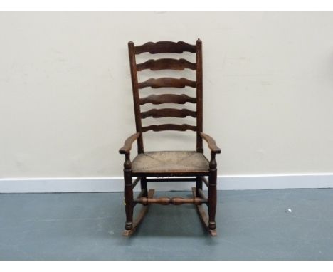 19th century beech provincial rocking chair with high ladder back.