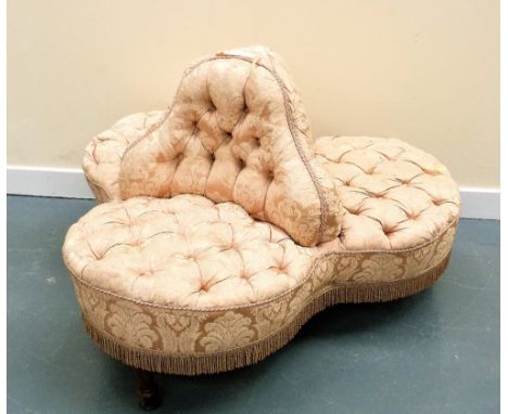 Victorian conversation settee of three lobed seats with button upholstery on turned walnut supports.