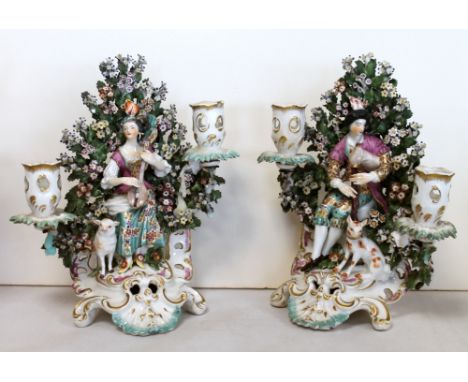 Pair of Derby porcelain "Pipe and Guitar" Shepherd and Shepherdess figural candelabra, c.1765, each with twin sconces, the fi