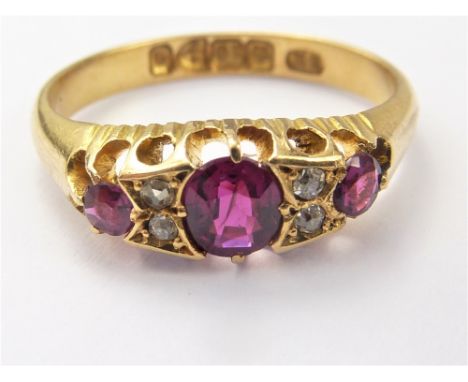 Victorian diamond and ruby seven stone ring. 1899. Size 'L'.