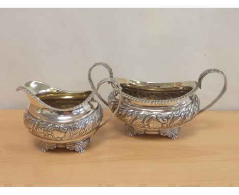 Silver embossed milk jug and sugar basin on winged paw feet. 1819/20 16oz (2) Condition Report. Both with slight wear, good m