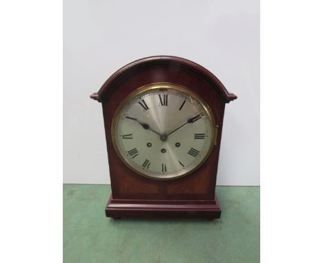 A mahogany arched top mantel clock with silvered Roman dial, eight day three train movement by Gustav Becker, 39cm high 