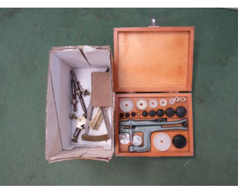 A box of watchmaker's tools including measuring gauge and glass fitting press 