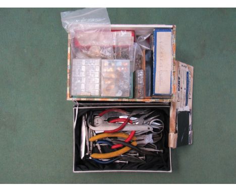 Two boxes of watchmakers tools and movement spares 
