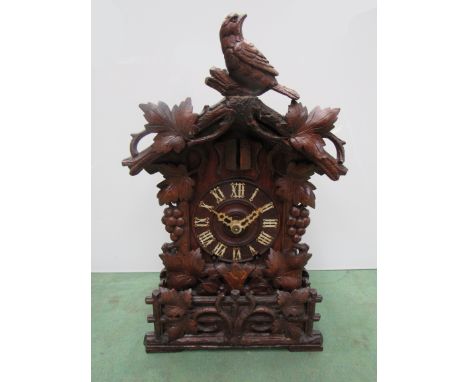 A late 19th Century carved oak cuckoo mantel clock with Roman chapter ring, with key, 44.5cm total height