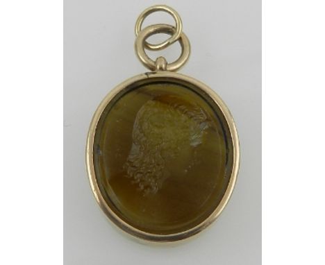 A yellow metal mounted glass intaglio portrait pendant of a Classical lady, signed by Nathaniel Marchant (1739-1816) 