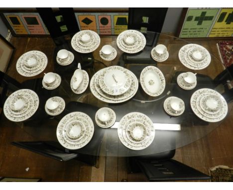 A Worcester Torquay part dinner and tea service, decorated with flowers, having gilt edge.